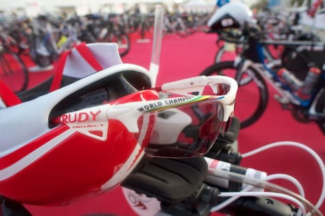 Rollison puts her glasses on in T1 then flips her helmet off her aerobars on to her head. Photo: Aaron Hersh