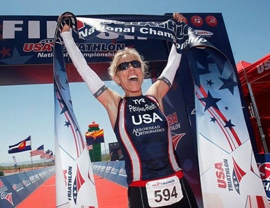 Patty Peoples takes the tape in the sprint-distance event. Photo: David Sanders/USA Triathlon