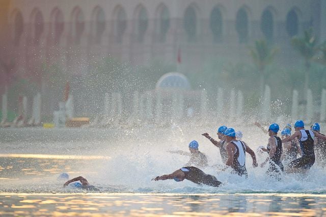 Athletes dive into the water at the 2010 Abu Dhabi International Triathlon. The first ITU WTS race in Abu Dhabi will start from a pontoon. Photo: Nils Nilsen