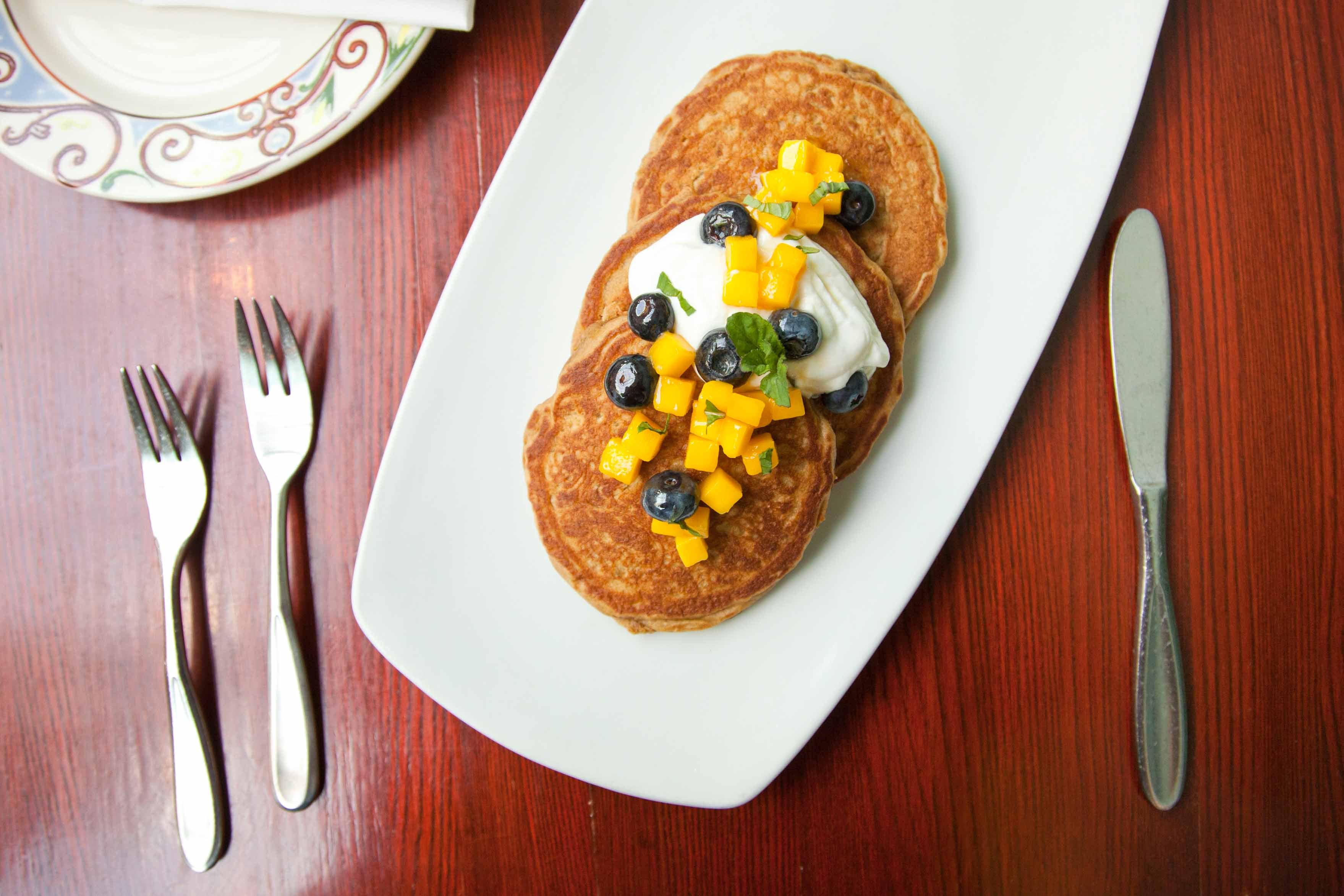 Whole-wheat quinoa pancakes with mango-blueberry salad. Photo: Felicia Perretti