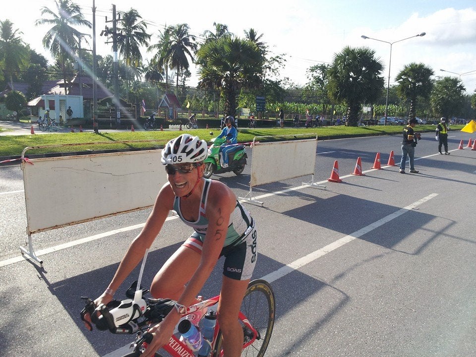 All smiles and sunshine on the Challenge Laguna Phuket bike course. Here I'm about to reach a mandatory dismount for a hike up and over a pedestrian bridge highway overpass, which athletes traverse twice during the race. Photo: Holly Bennett