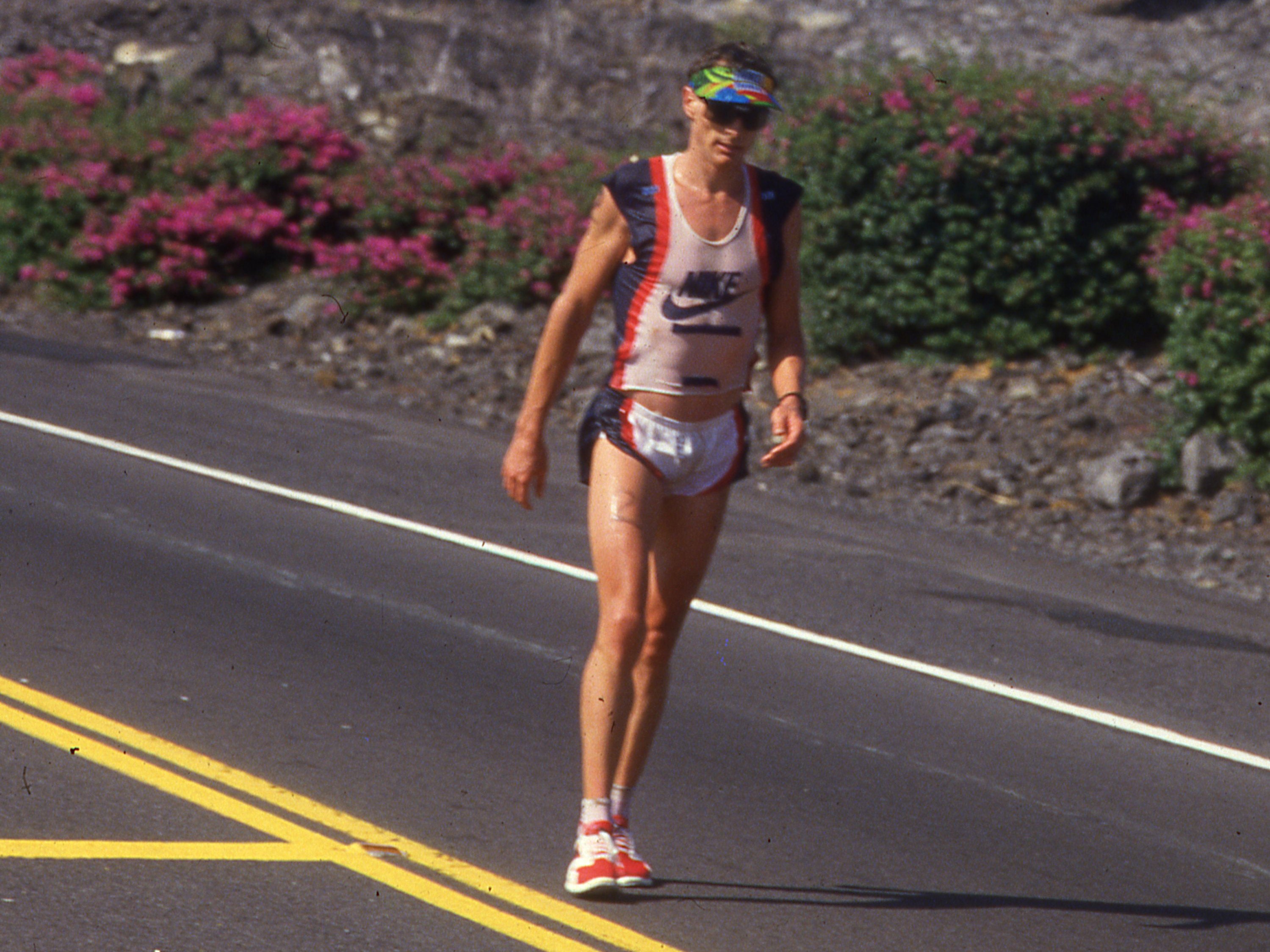 Miles after breaking away to a substantial lead during the 1987 Ironman Hawaii marathon, Mark Allen slowed to
a walk and Dave Scott left him behind yet again. Photo: Lois Schwartz