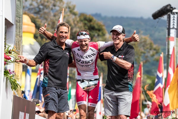 Ironman legends Dave Scott and Mark Allen greeted Jan Frodeno at the finish line at the 2016 race. Photo: Paul Phillips/Competitive Image