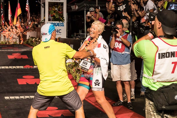 Mike Reilly welcomes the final finisher, Jennifer Tait of Great Britain. 