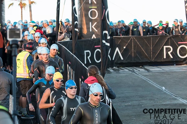 Athletes line up for their turn to walk down the ramp and into the water at Ironman 70.3 Oceanside. Photo: Paul Phillips/Competitive Image