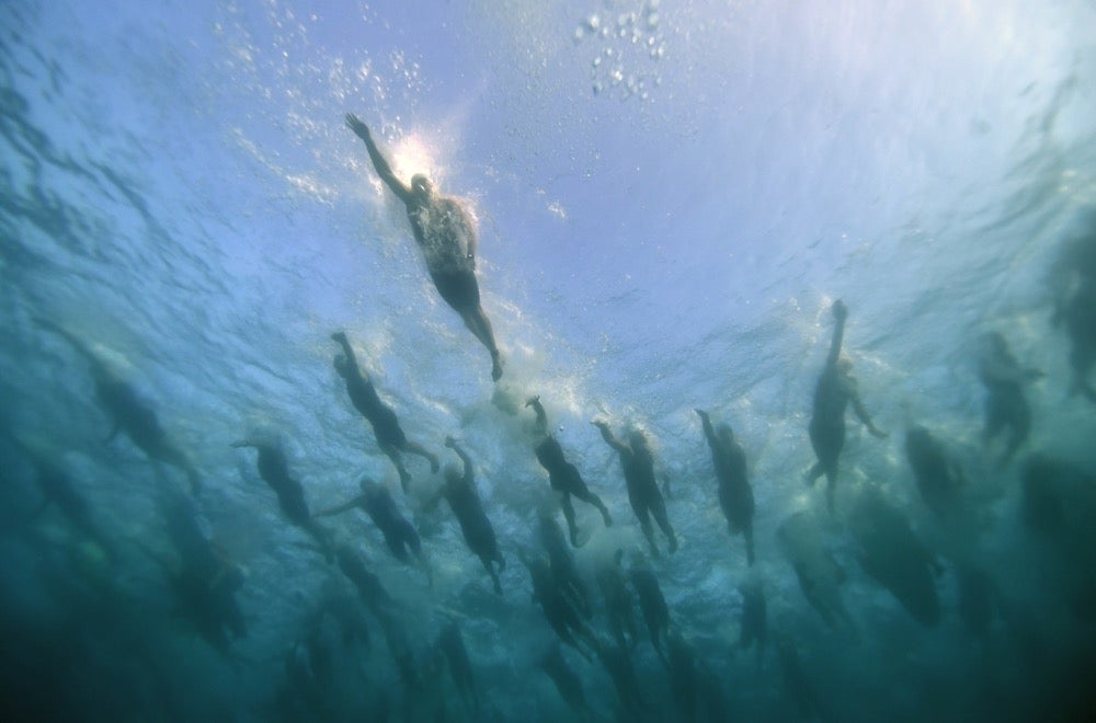 Athletes school like fish as they begin their 2.4-mile swim as part of the 2017 Ironman World Championship in Kailua-Kona, Hawaii. Photo by Donald Miralle/Ironman