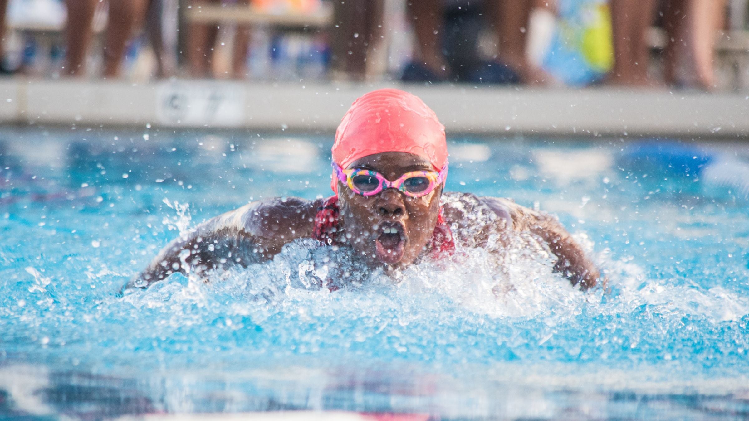 A swimmer is Swimming the Butterfly stroke