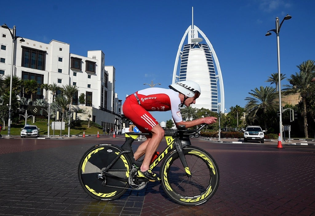 Alistair Brownlee of Great Britain cycles past Burj Al Arab. Photo: Tom Dulat/Getty Images for Ironman