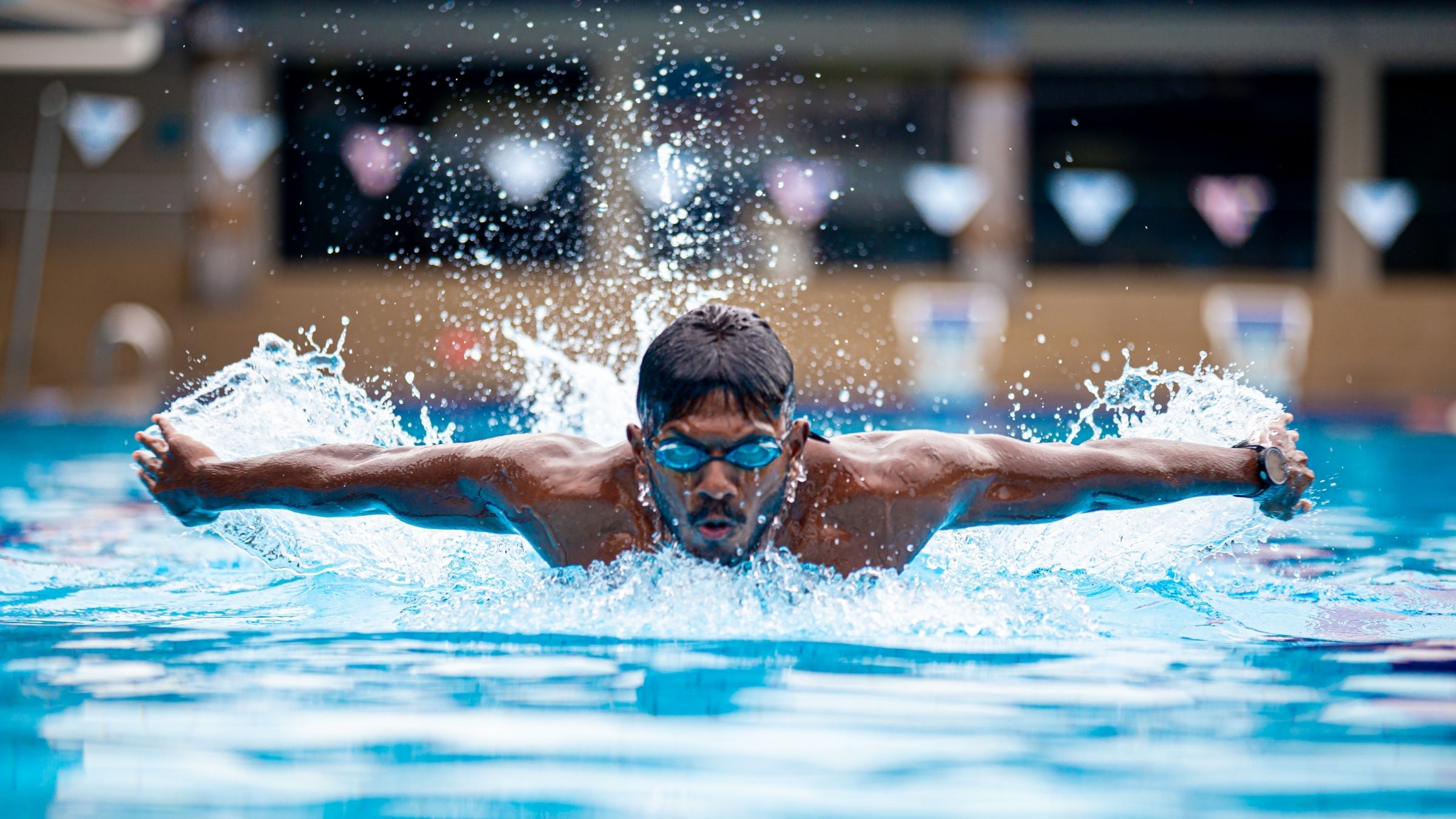 An athlete swims in a pool during a one-hour weekend workout