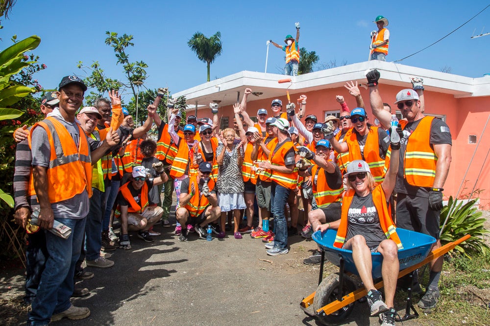 Almost unrecognizable from the morning, Maria poses for a group photo with her new friends.  
<br><br>
The new wheelbarrow was purchased during the day. Although there was a wheelbarrow on site, the tire was so bad, after it was filled it couldn't be rolled - just lifted. Someone made a quick decision and went and purchased a new one!
