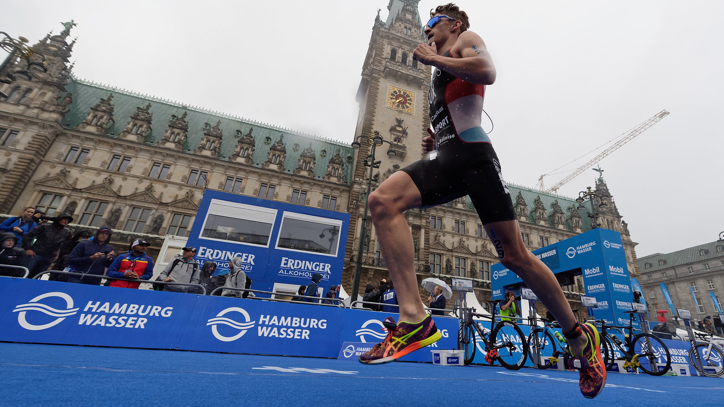An athlete runs in sockless running shoes.