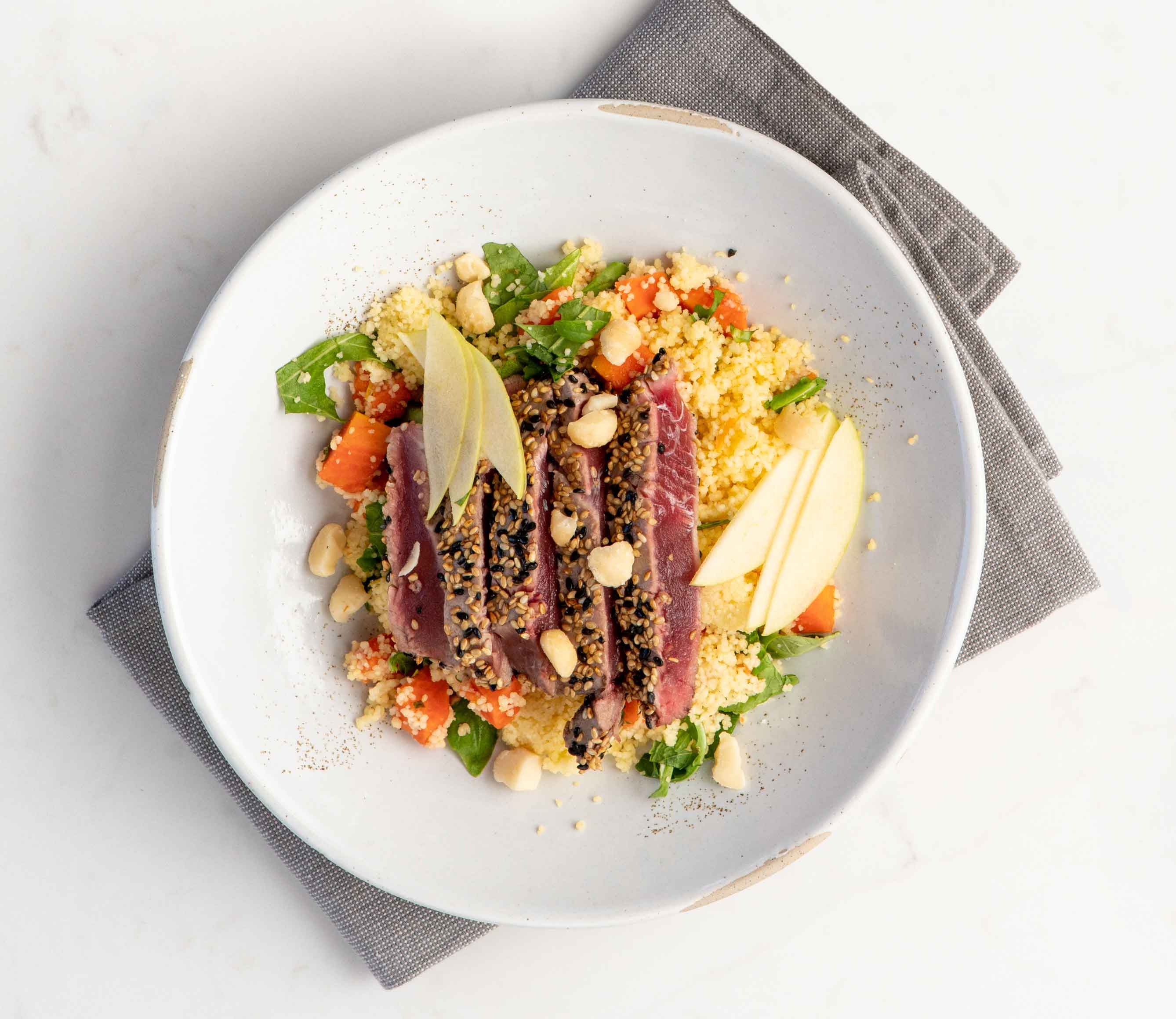 Pictured: Sesame Seed Crusted Hawaiian Ahi with Papaya and Ginger Israeli Couscous. Photo: Cast Iron Culinary