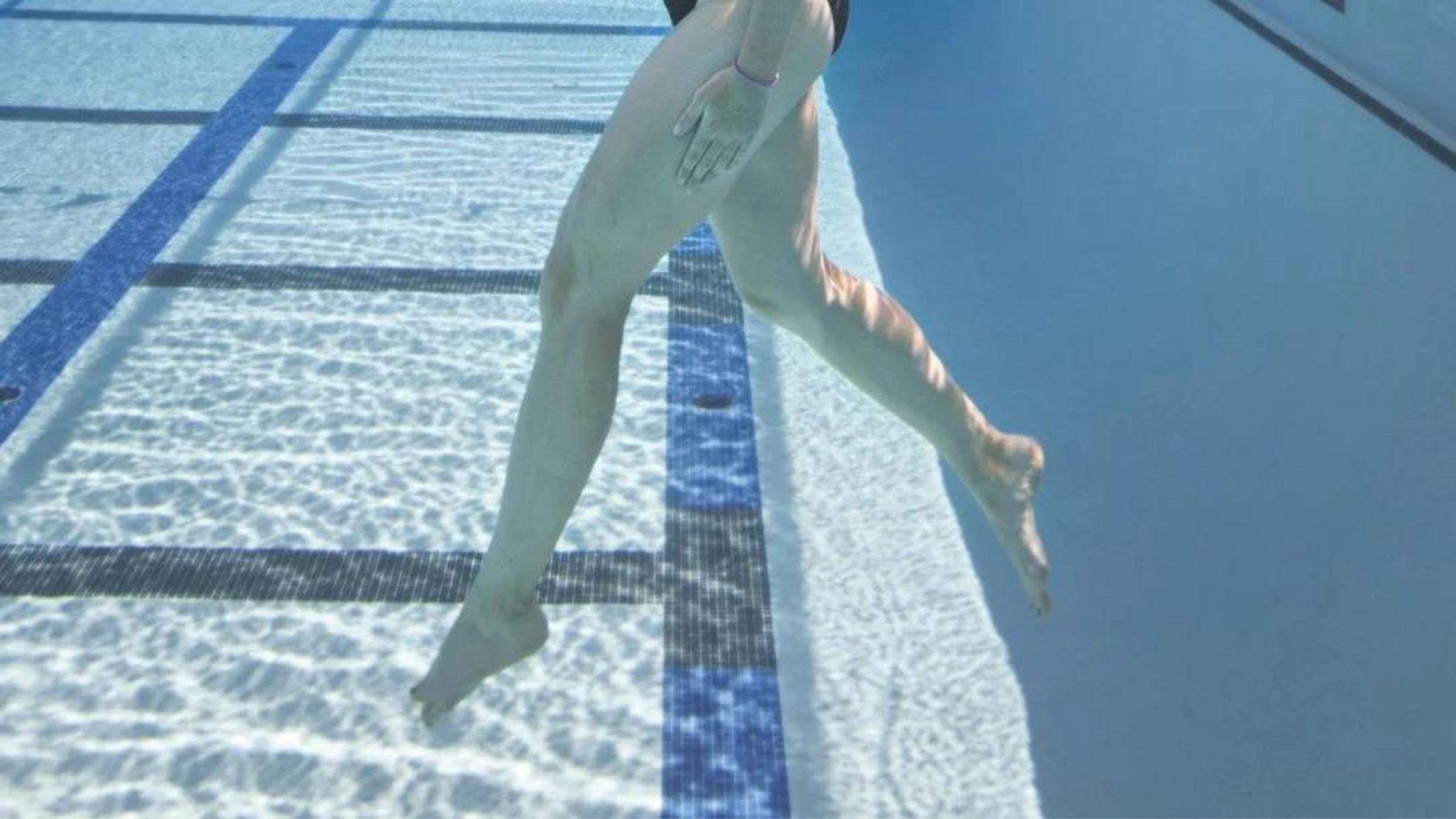 A triathlete demonstrates a swimming vertical kick drill