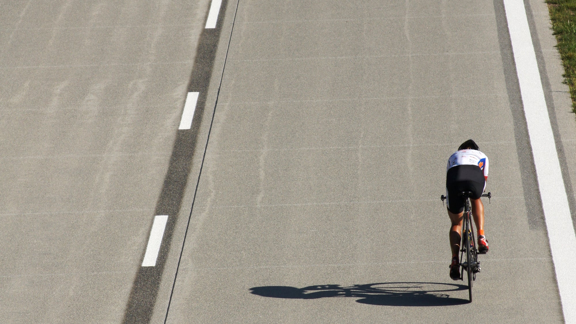 A triathlete on a road completing a bike fitness test.