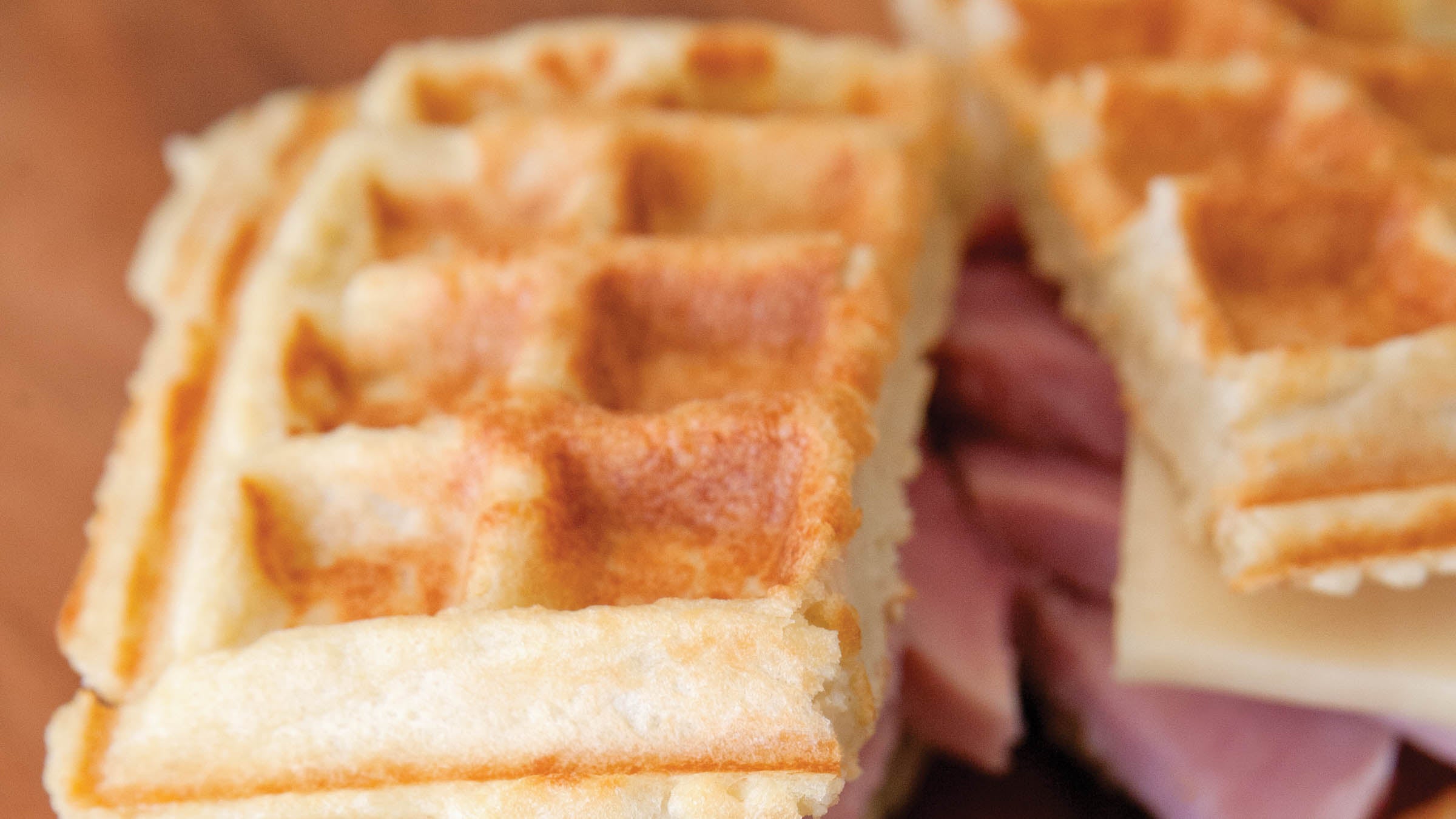 cheesy potato waffle sandwich with ham and swiss