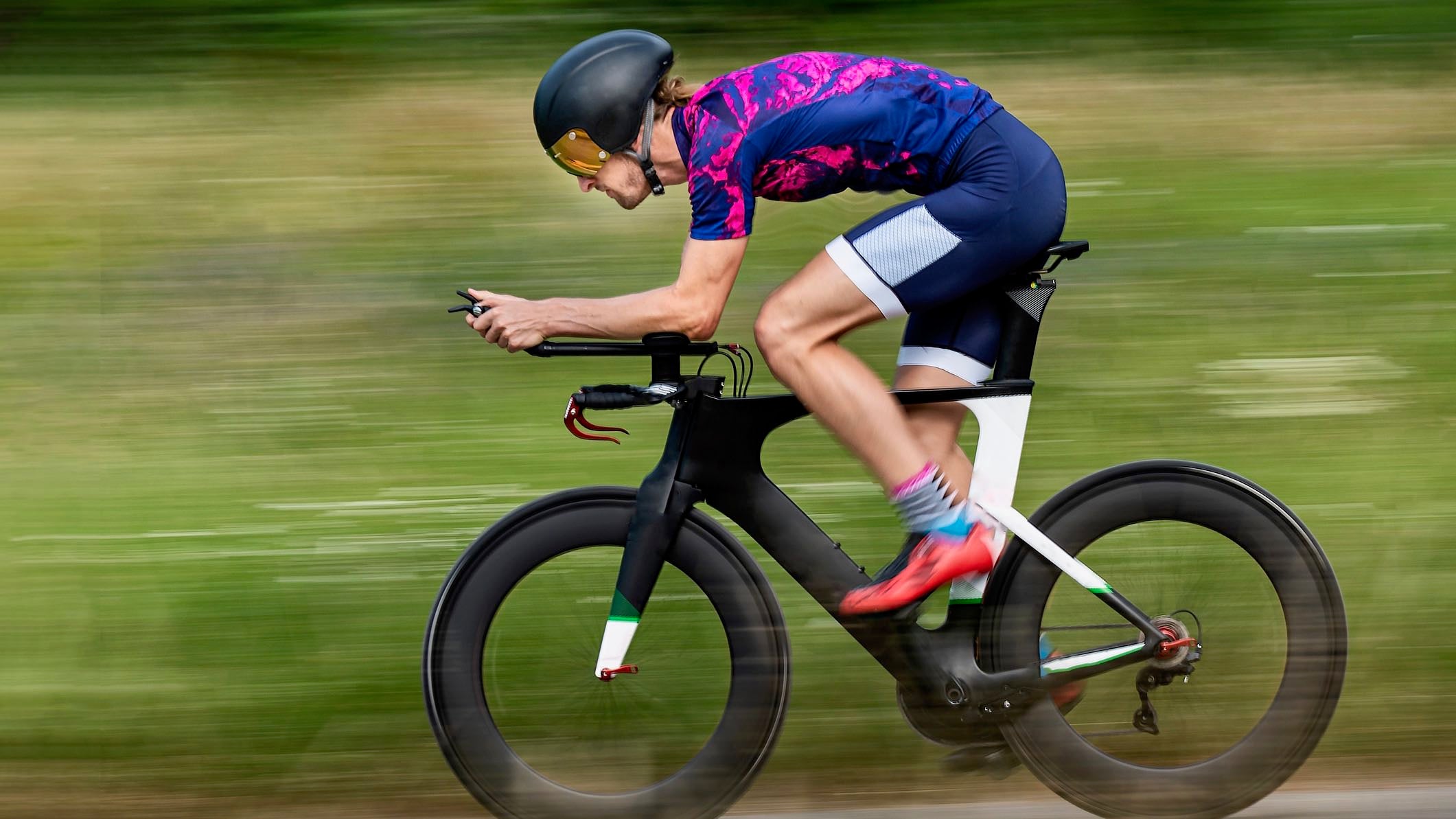 Triathlete rides bike during a benchmark testing set.