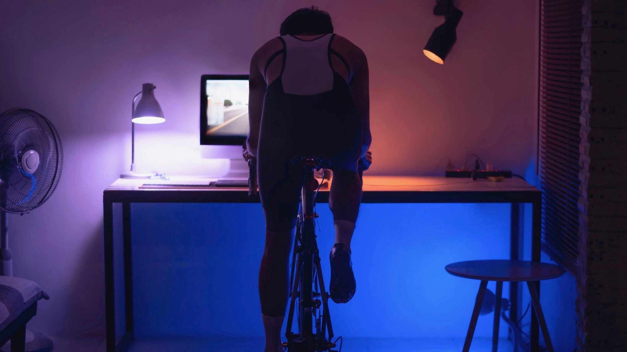 A triathlete on an indoor trainer completing bike sprints to improve short hill climb and cornering skills.