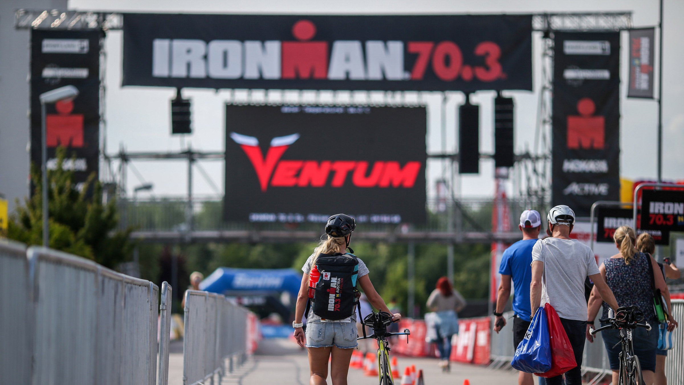 Athletes walk into the Ironman village at a 70.3 event.