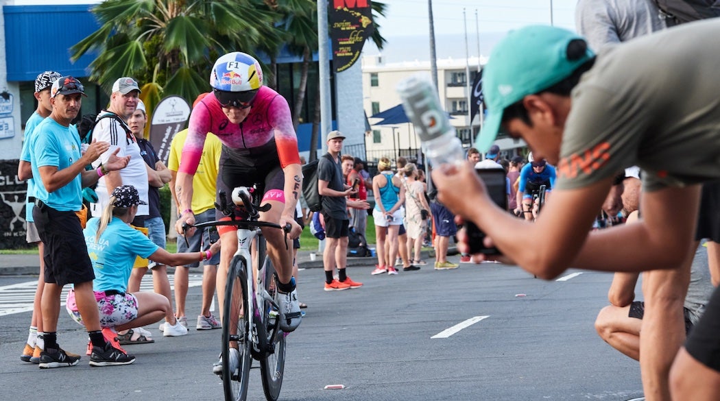 Woman riding down a fan-lined street
