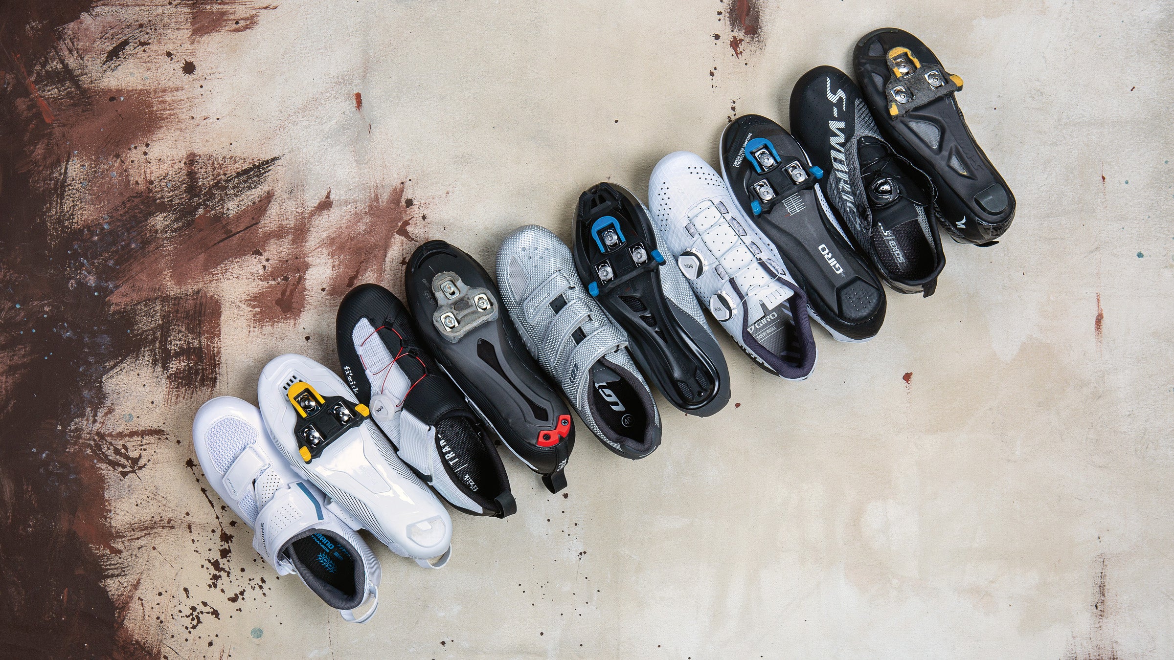 An assortment of cycling shoes in a line