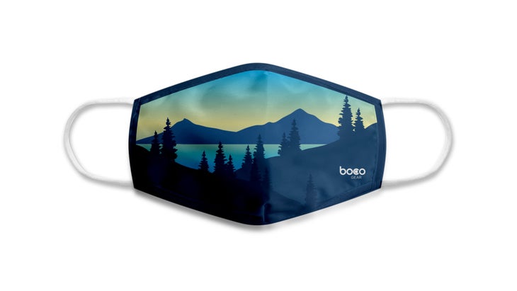 Blue face mask with mountains and trees on it