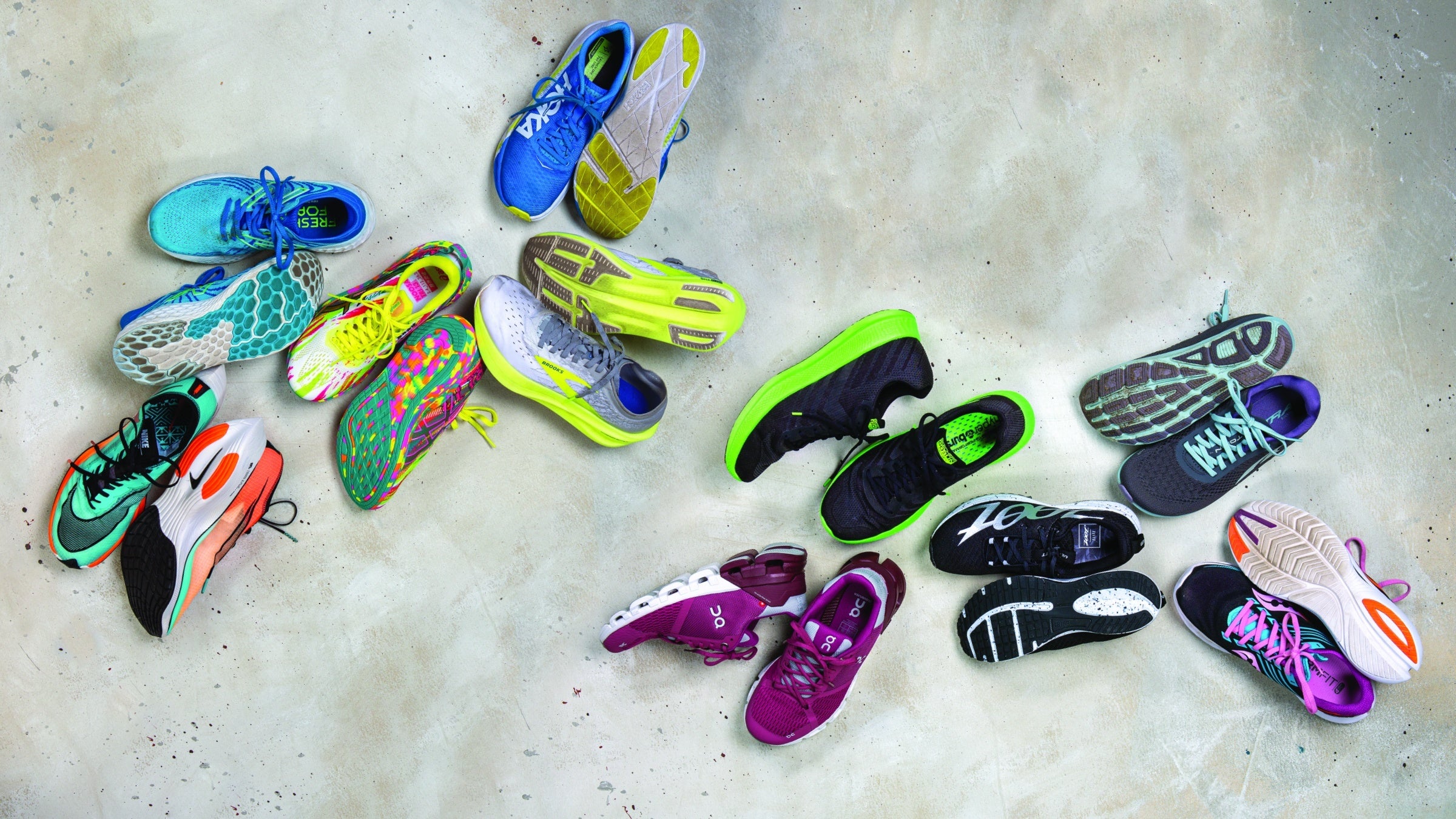 Colorful assortment of running shoes on concrete