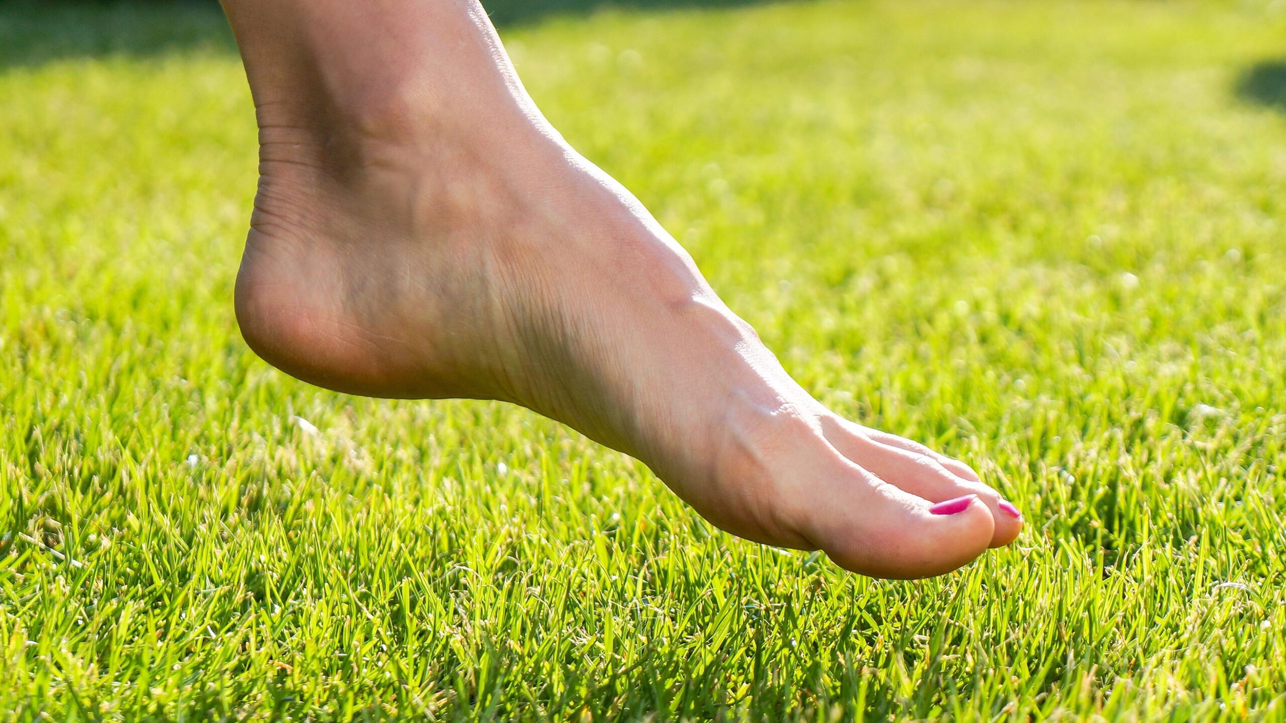 Foot over grass