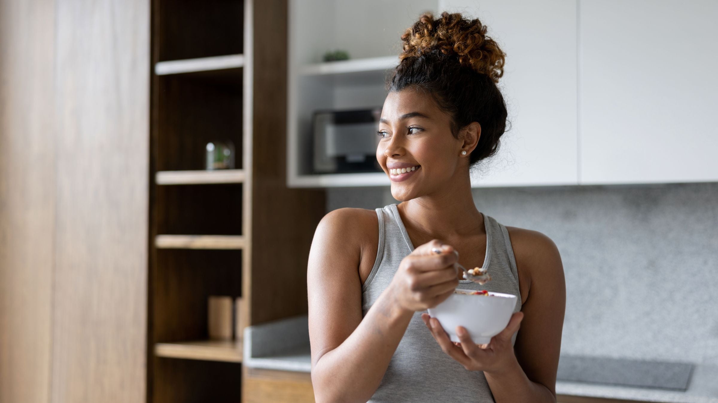 A woman recovers by eating the best foods to eat after a workout.