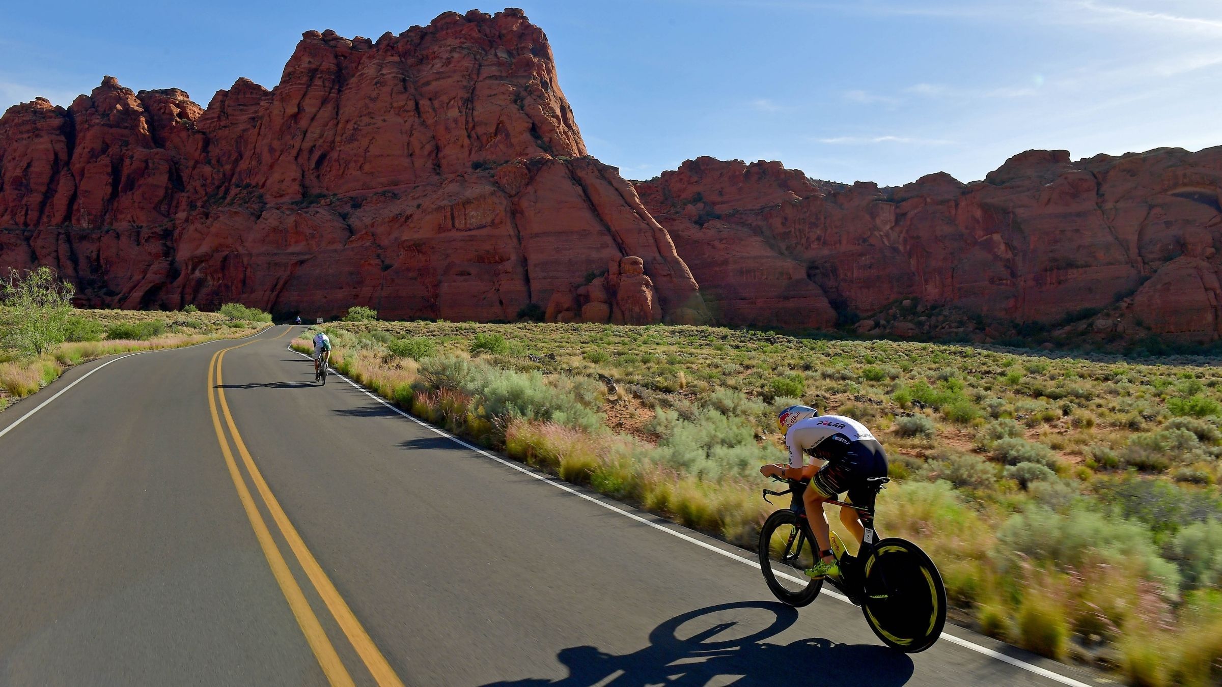 Triathletes riding bikes on the Ironman St. George bike course.