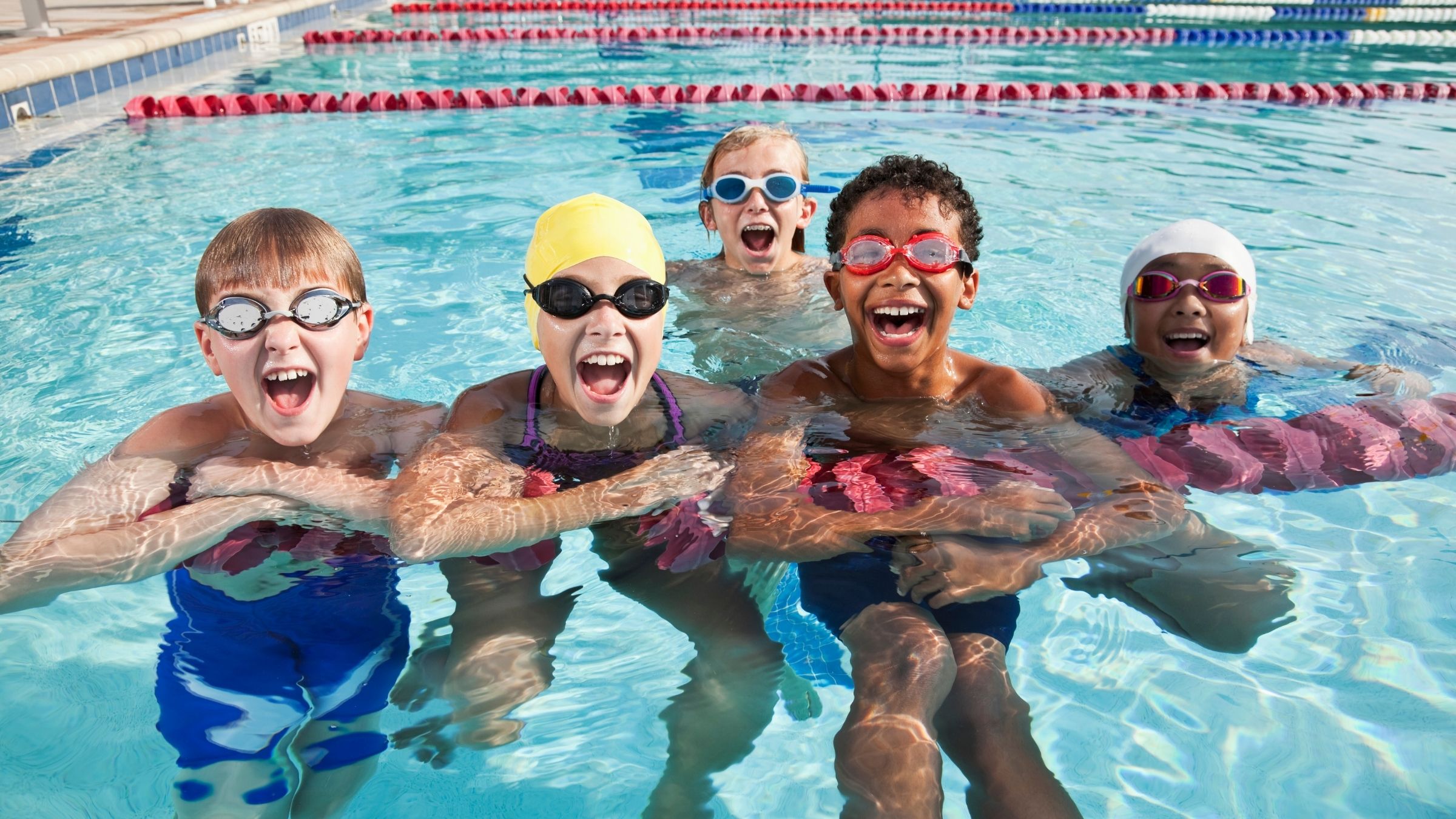 Kids training for a triathlon in the pool.