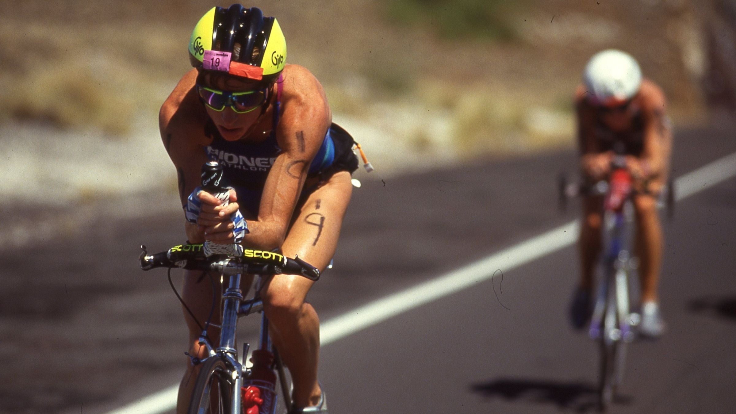Triathlete Erin Baker rides a bike in an Ironman