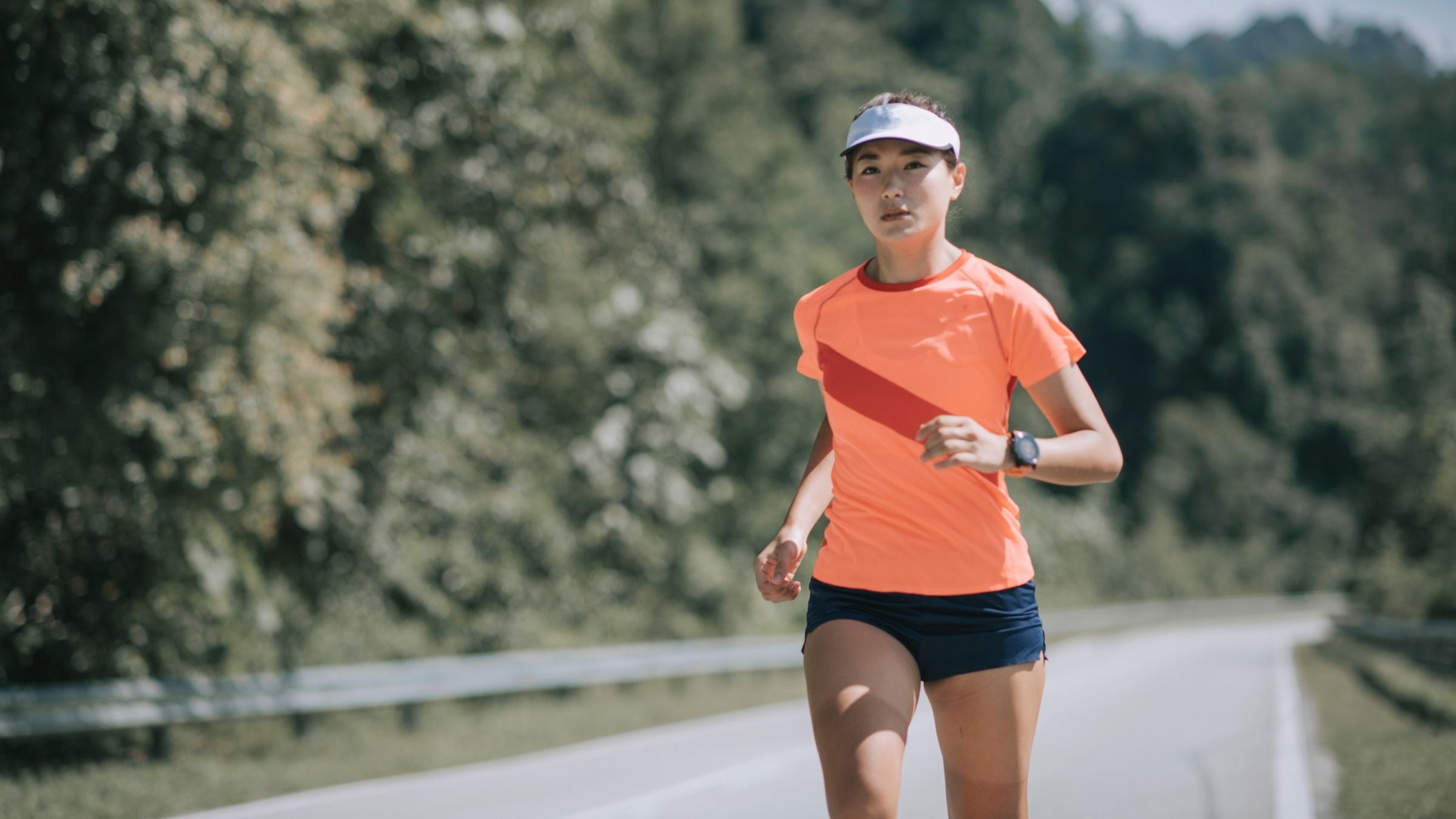 A woman running her fastest 10K ever thanks to the 10k training plan.