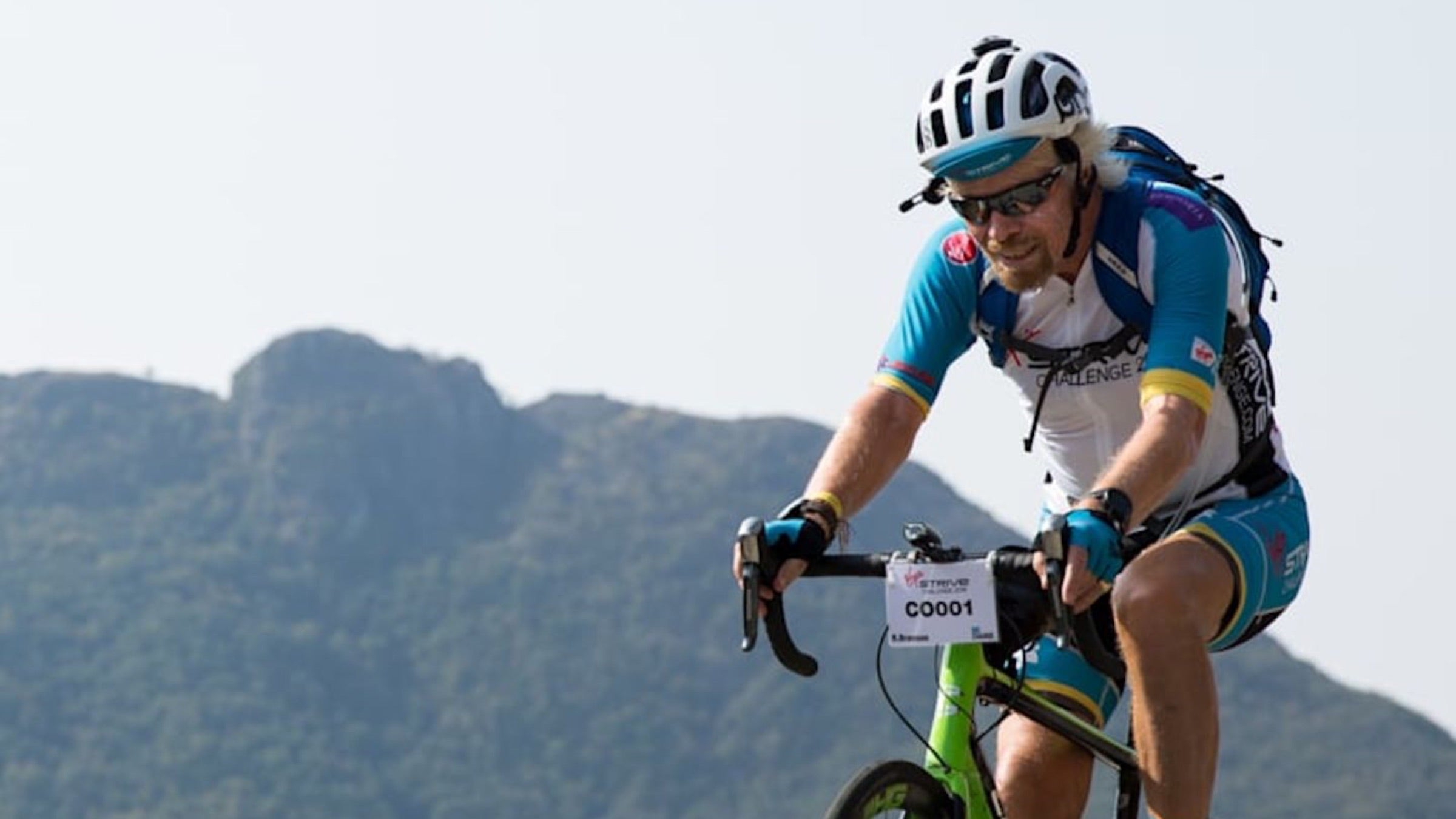 Richard Branson rides his bike in the Virgin Strive Challenge in 2020.