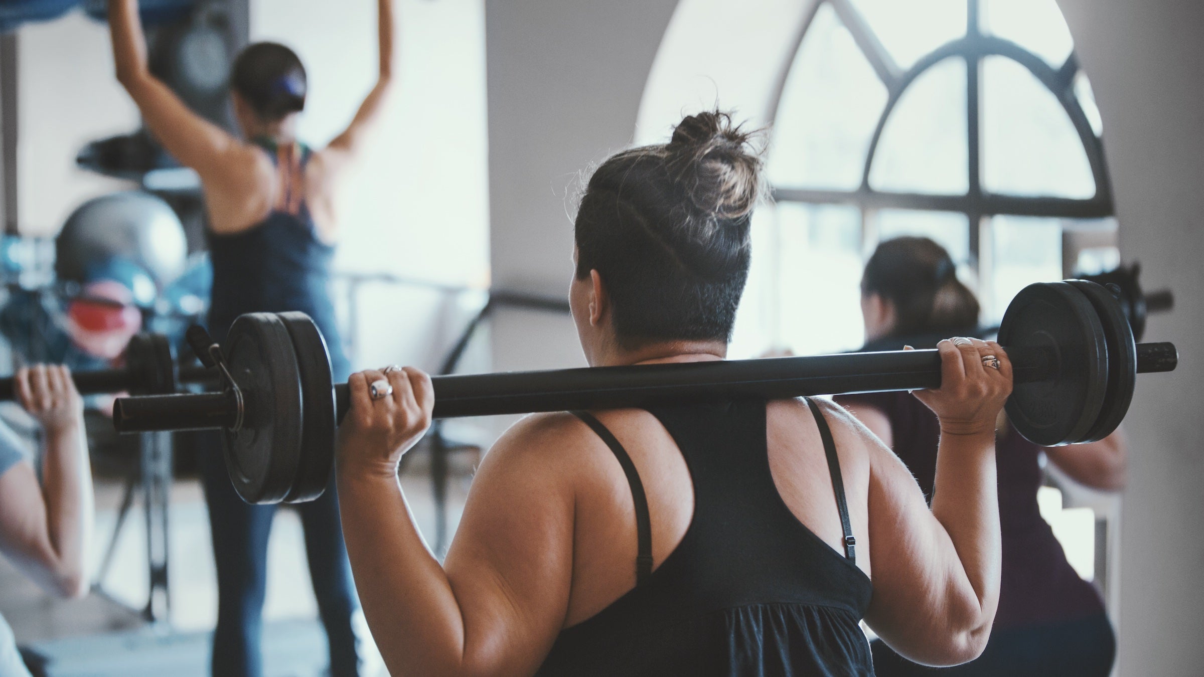women lifting weights in gym
