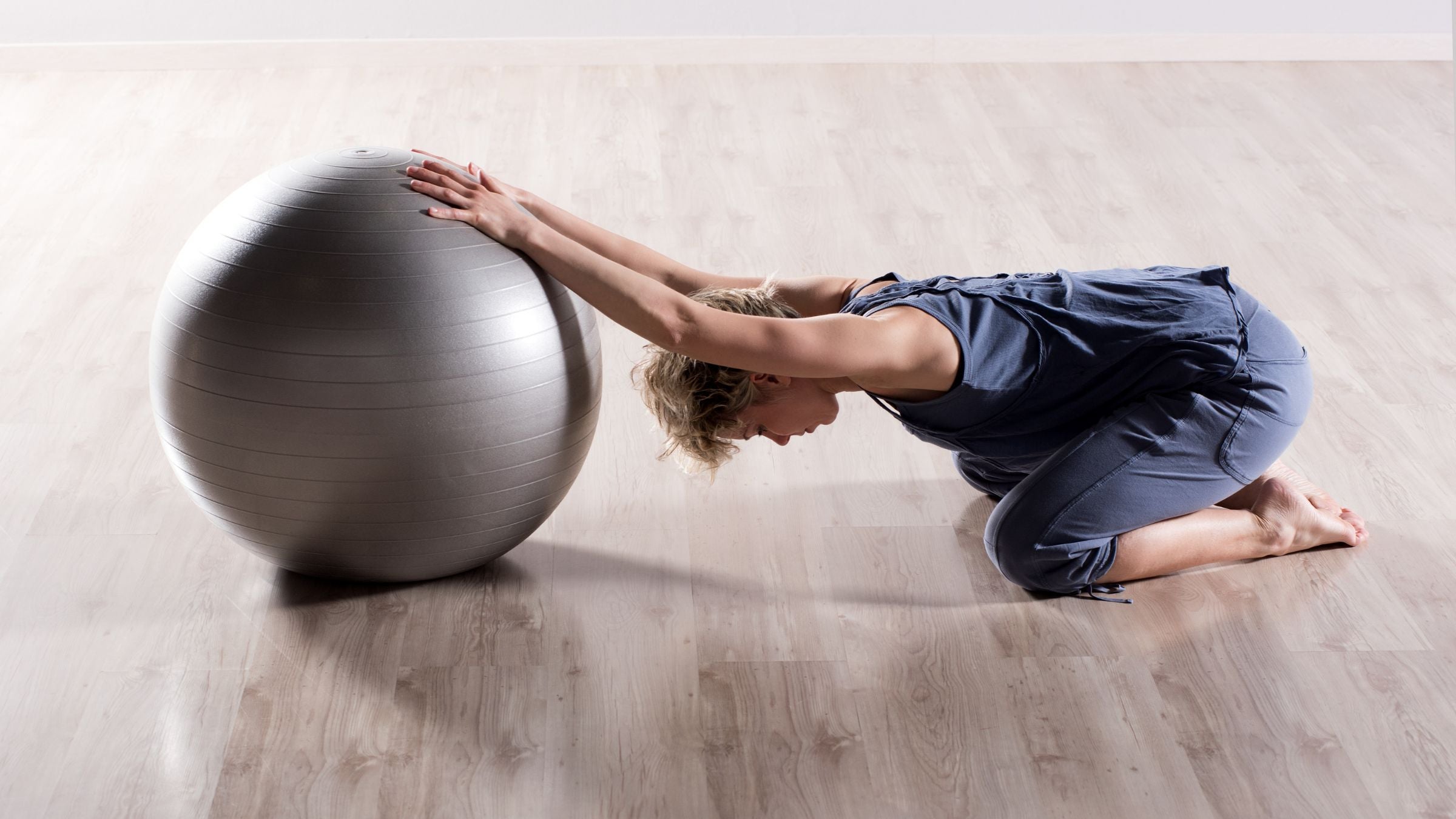 A woman does stretches for tight shoulders