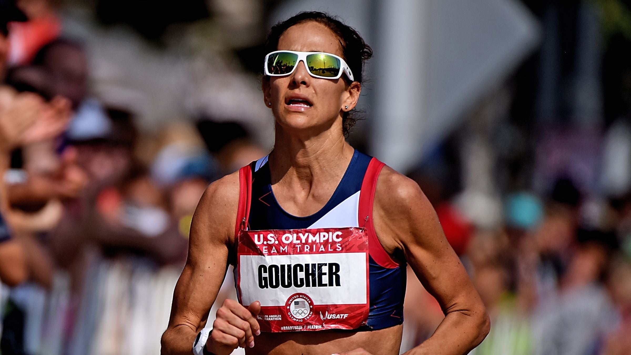 Kara Goucher runs in a race. The Olympian was recently diagnosed with Runner's Dystonia, leaving many wondering "What is runner's dystonia?"