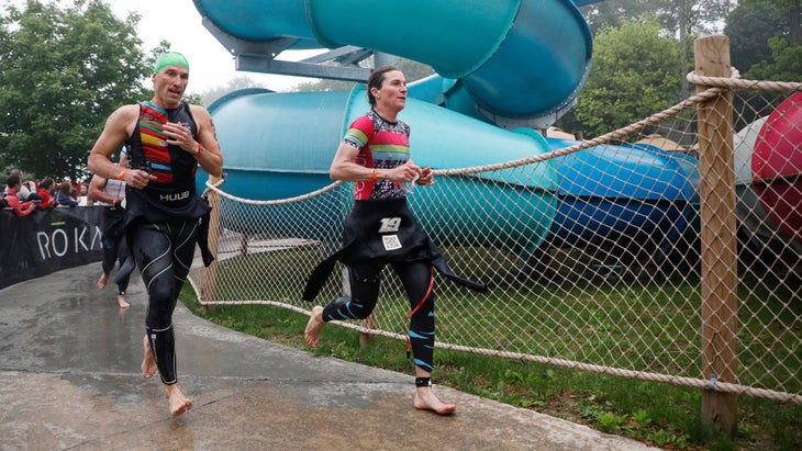 Two triathletes wear tri suits under their wetsuit at their first triathlon.