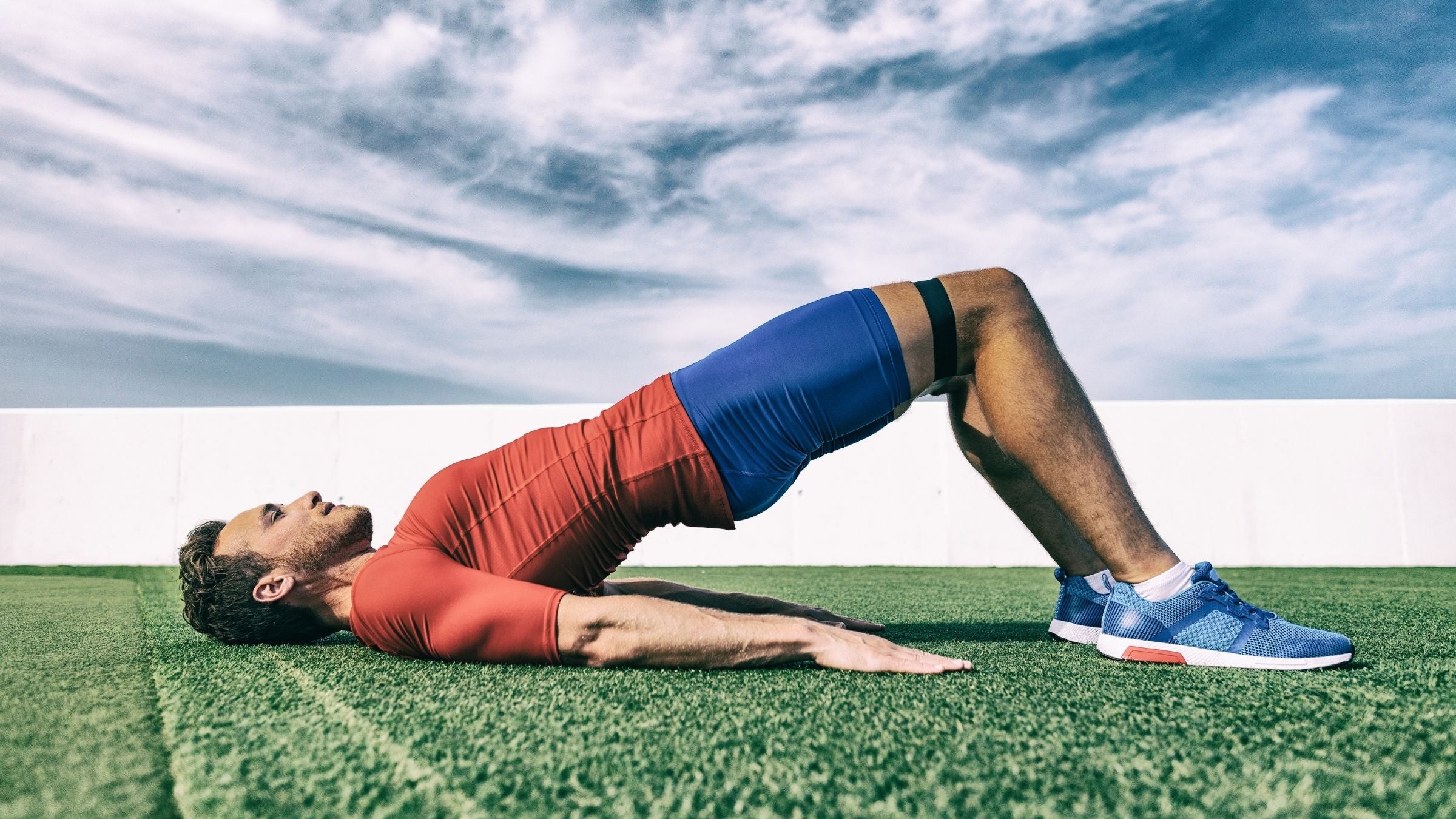A man does a glute bridge, one of the best hip exercises for runners.