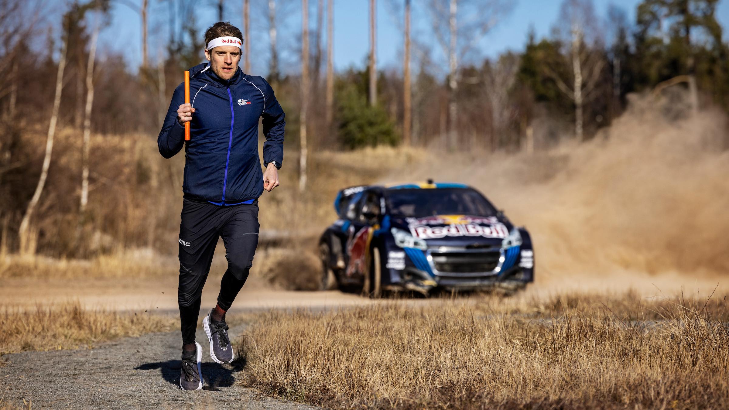 Patrik Nilsson runs against a race car.