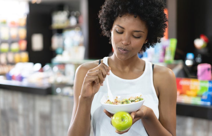 A woman eats to carb-load before a race.