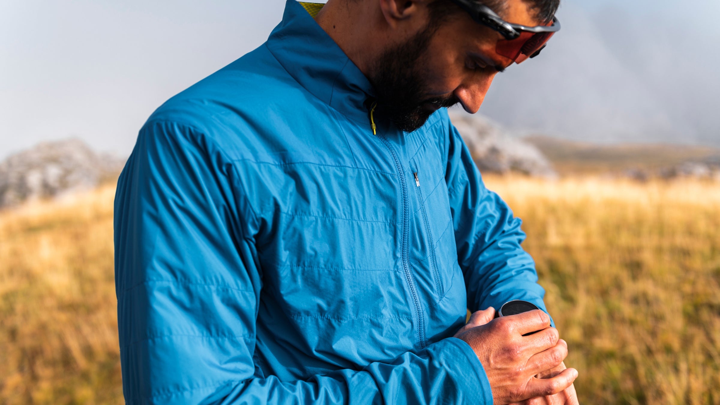 Trail runner using training watch on a foggy day
