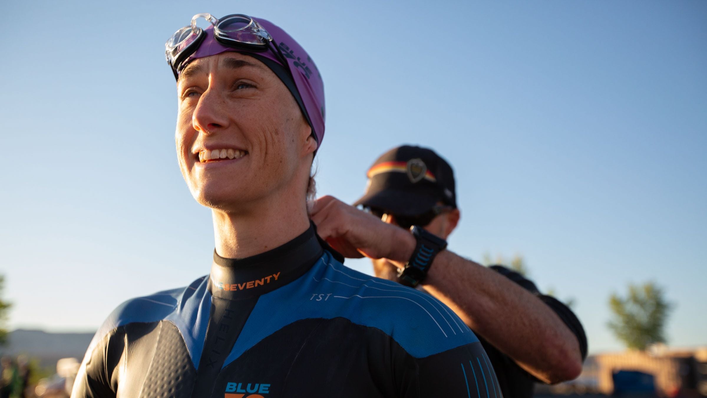 A triathlon swimmer decides between a sleeveless and sleeved wetsuit