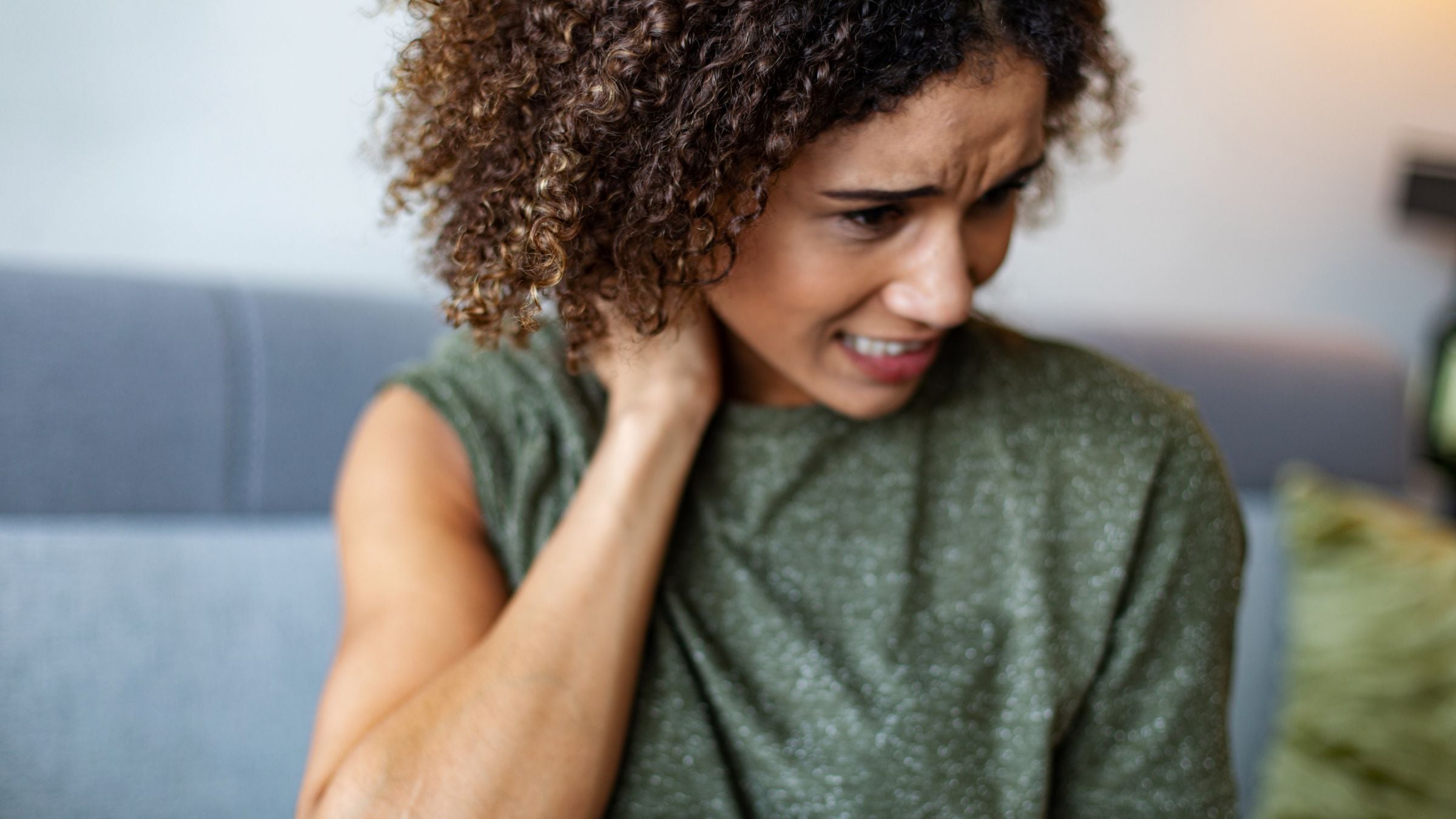 A woman massages her sore muscles