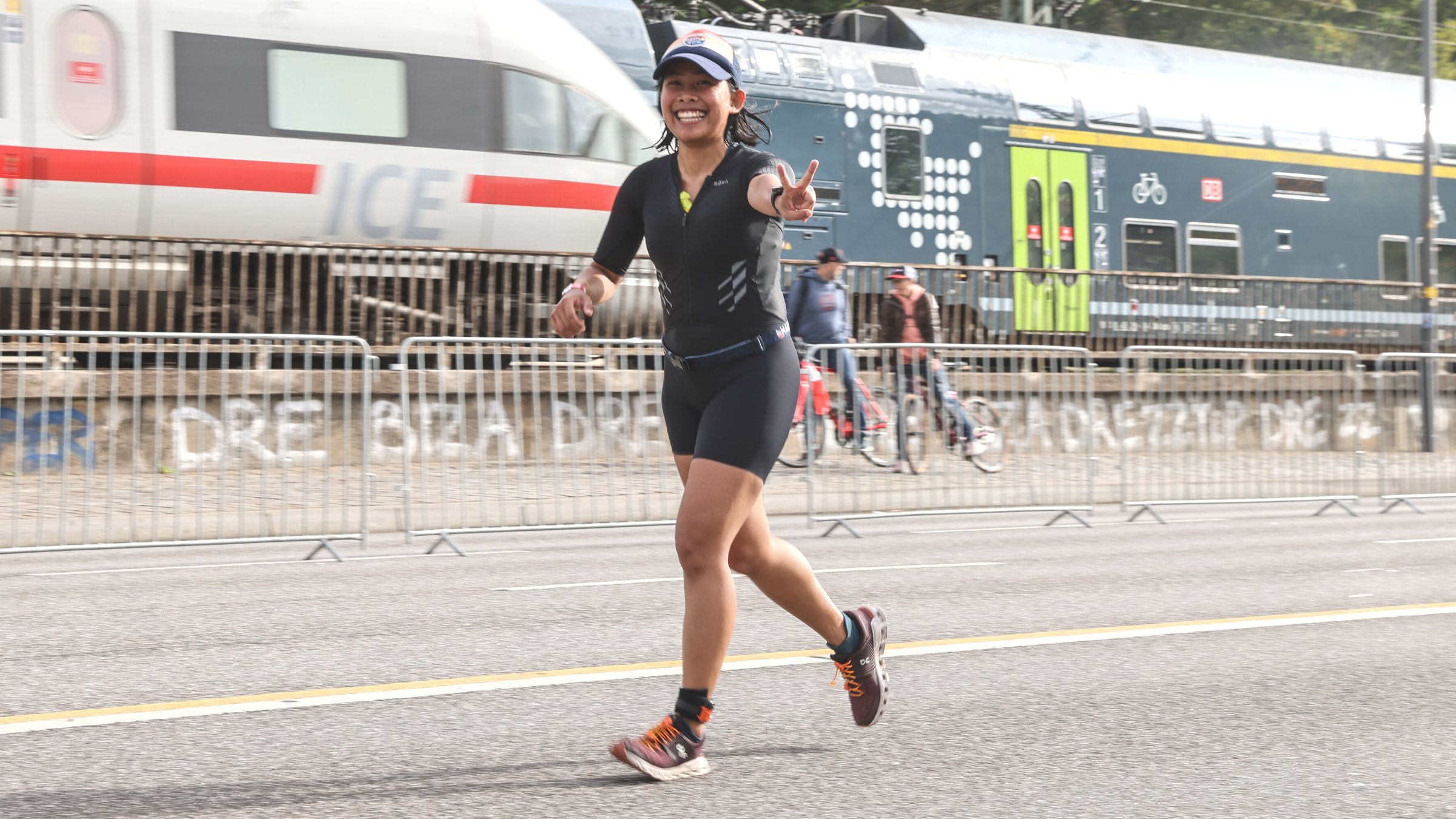 A triathlete smiles as she races a triathlon. She knows she is ready to race again.