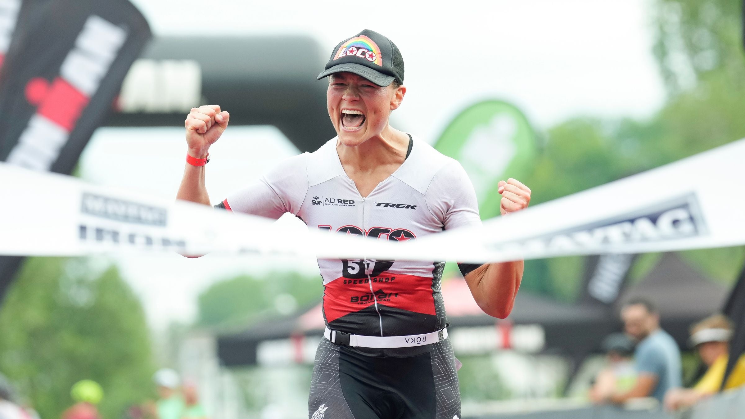 Age-grouper Dani Fischer celebrates as she crosses the finish line to win the Women's Division at IRONMAN 70.3 Steelhead.