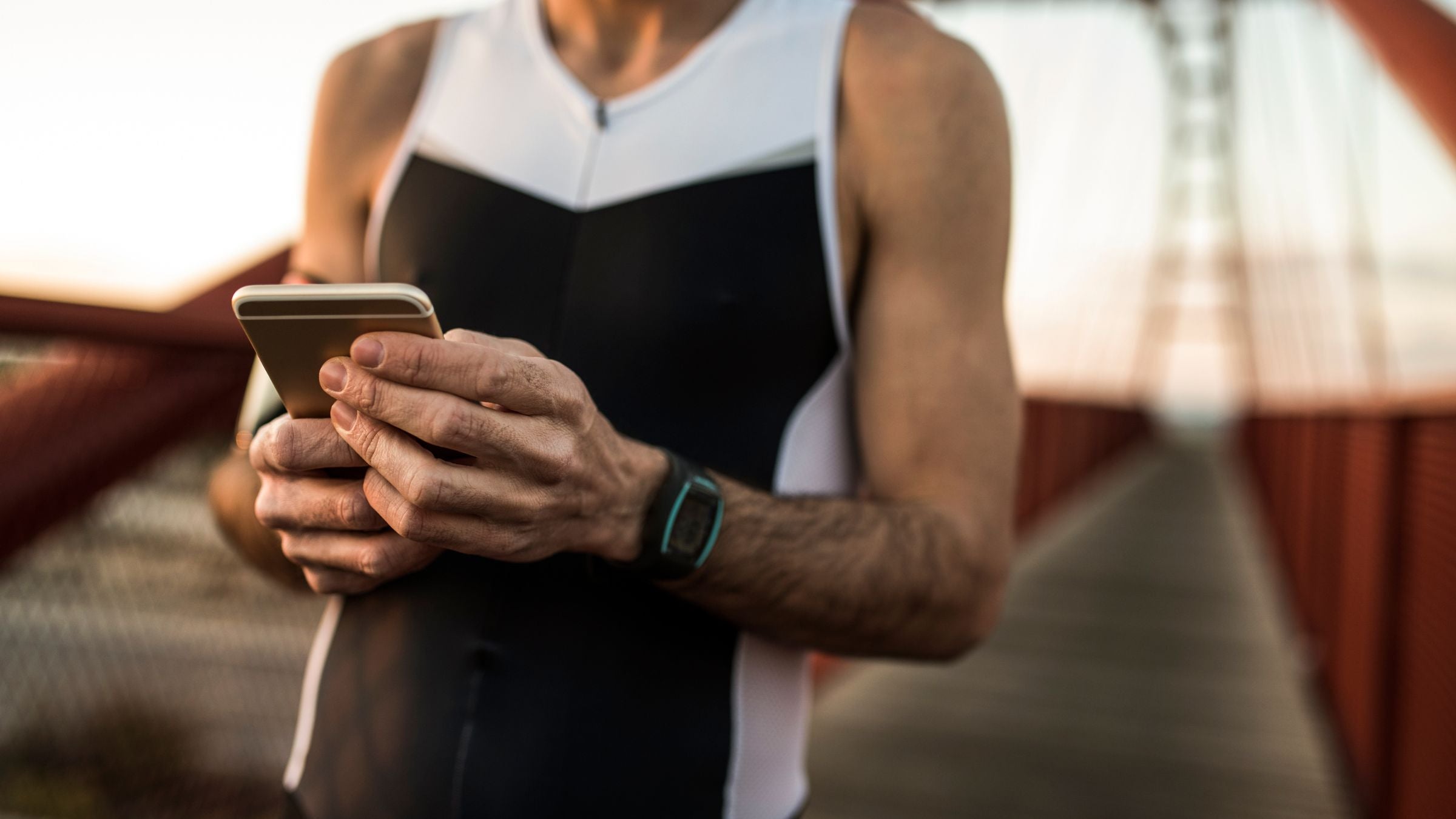A triathlete checks his TrainingPeaks metrics on his phone.