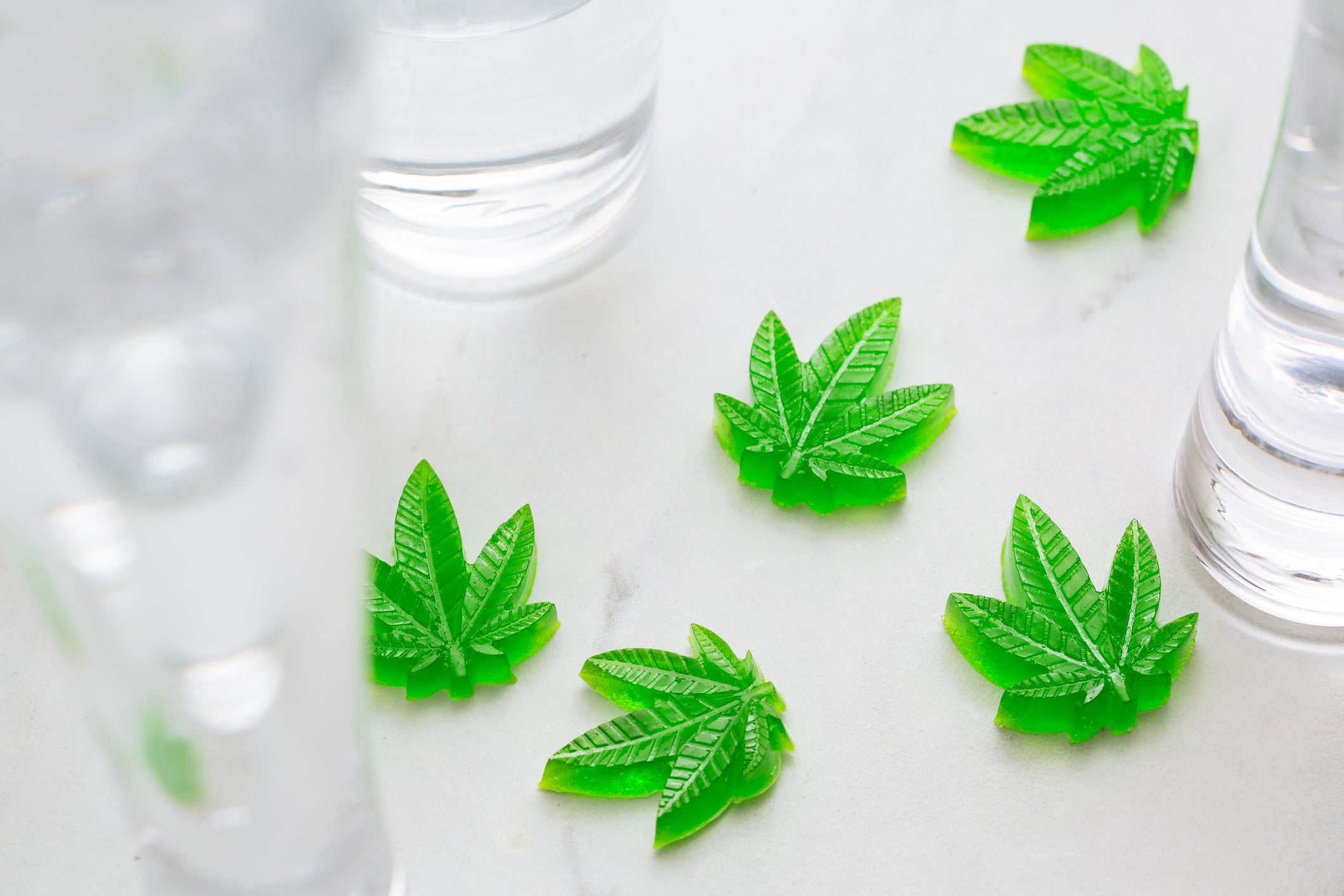 Green gummy candies shaped like marijuana plants for athletes