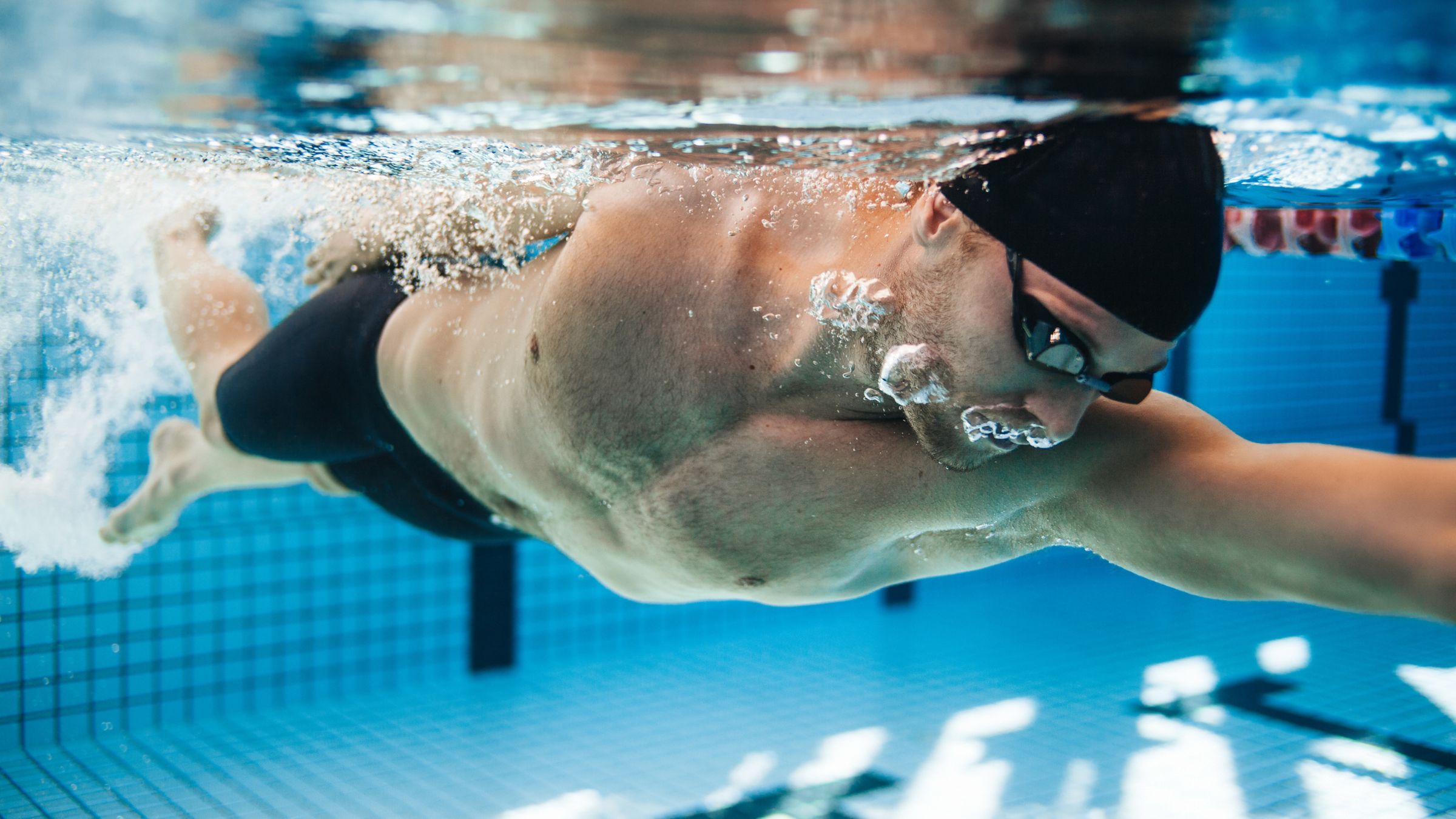 A triathlete completes a no-walls swim training session in the pool to mimic open-water swimming for his next race.