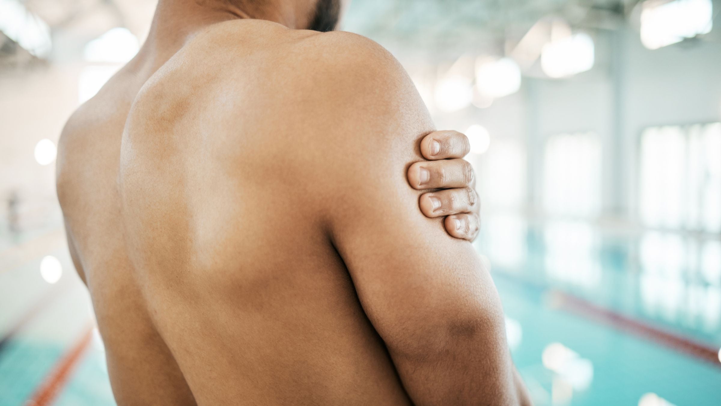 A swimmer does exercises to stretch and strengthen rotator cuffs.
