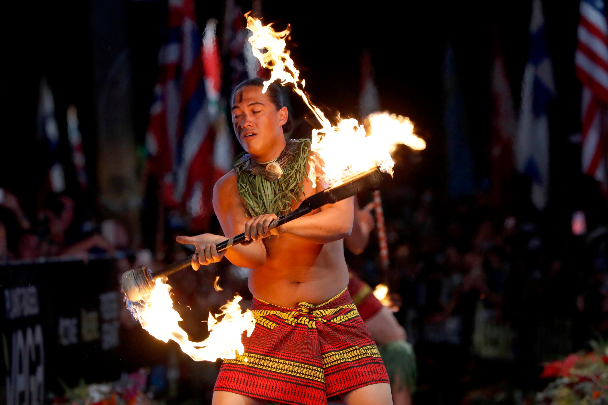Hawaii fire dancers perform after the Ironman World Championships on October 12, 2019 in Kailua Kona, Hawaii.
